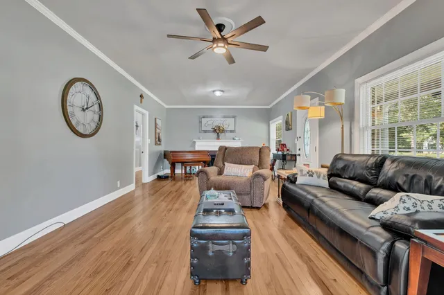 a living room with furniture and wooden floor