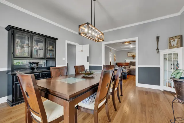 a view of a dining room with furniture and wooden floor