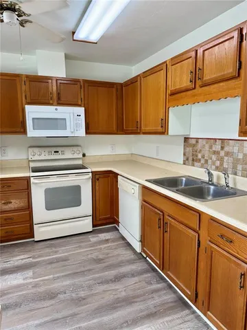 a kitchen with cabinets a sink and appliances