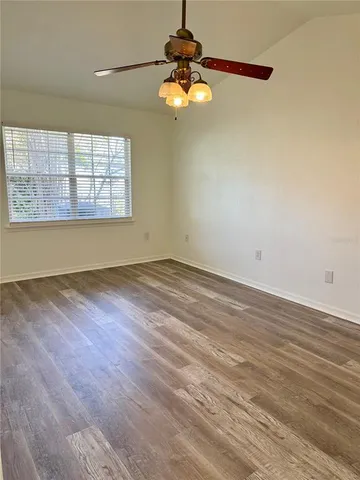 a view of wooden floor and windows in a room