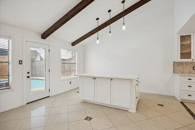 a view of a kitchen with white cabinets