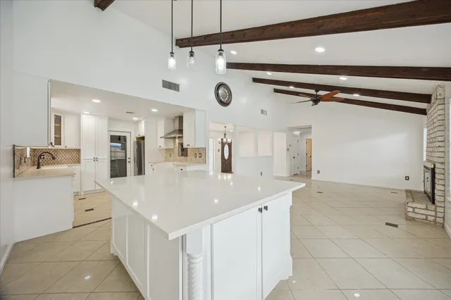 a kitchen with a sink appliances and cabinets