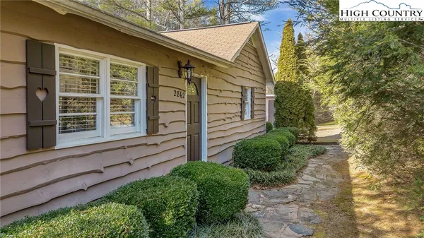 a view of a house with a yard and sitting area