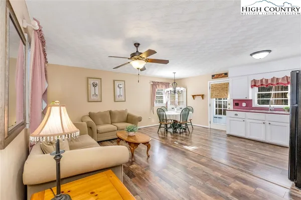 a living room with furniture dining table and a large window