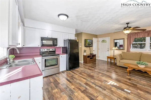 a kitchen with a refrigerator stove and sink