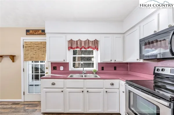 a kitchen with cabinets and window