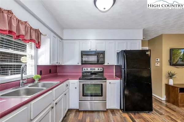 a kitchen with a refrigerator stove and sink