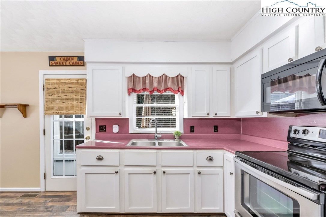2862 Lower Nettle Knob Road West Jefferson, NC 28694 - Photo 24 of 48 a kitchen with cabinets and window