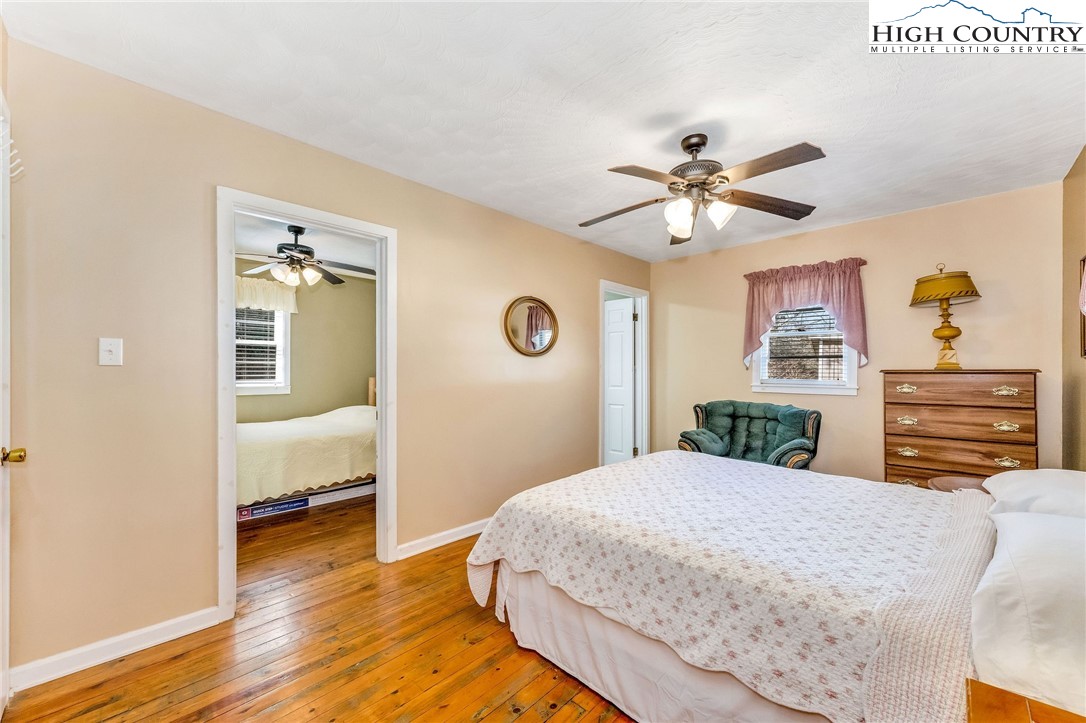 2862 Lower Nettle Knob Road West Jefferson, NC 28694 - Photo 26 of 41 a bedroom with a bed and a chandelier