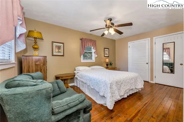 a spacious bedroom with a bed and a chandelier