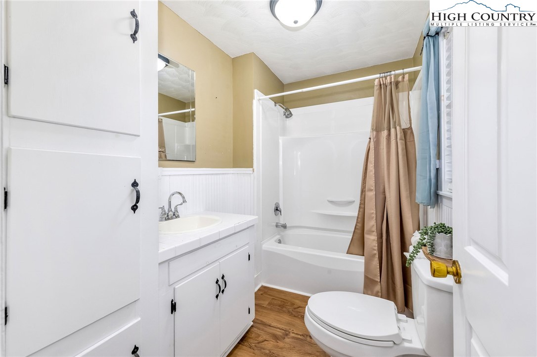 2862 Lower Nettle Knob Road West Jefferson, NC 28694 - Photo 37 of 48 a bathroom with a sink a toilet and shower