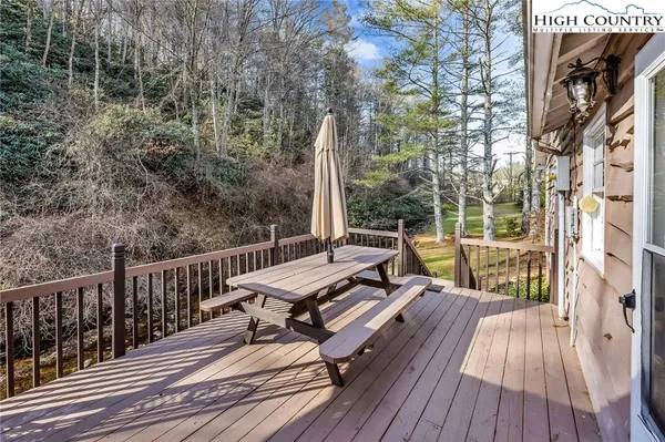a view of balcony with wooden floor and outdoor seating
