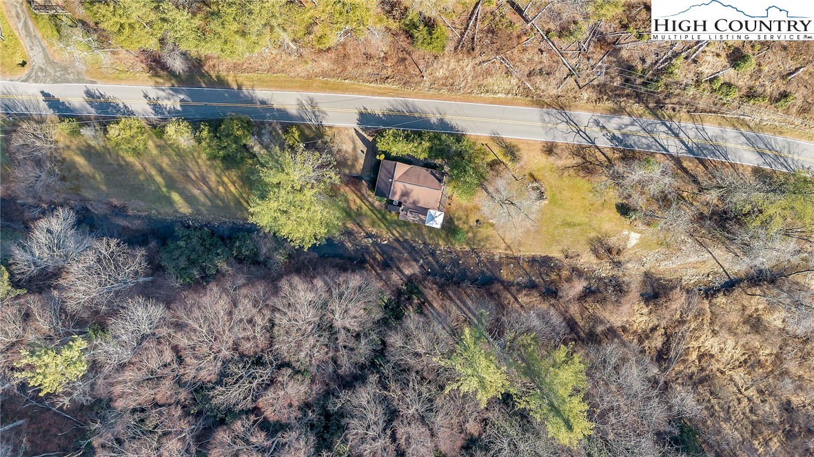 2862 Lower Nettle Knob Road West Jefferson, NC 28694 - Photo 6 of 41 a view of a yard with plants and wooden fence