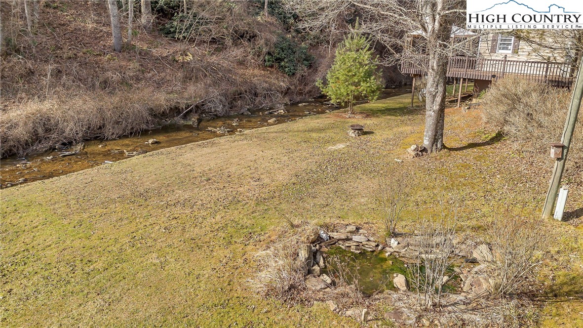 2862 Lower Nettle Knob Road West Jefferson, NC 28694 - Photo 9 of 41 a view of a yard with brick wall and fence