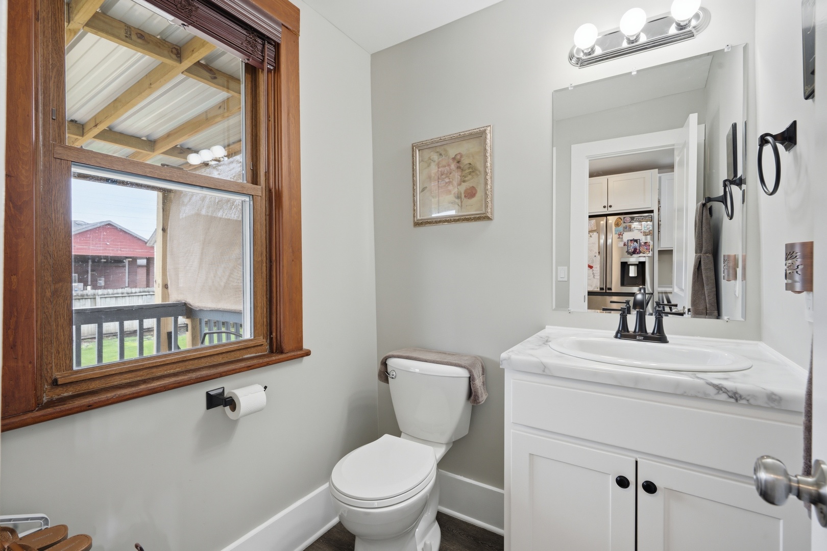 1507 Pershing Boulevard Clinton, IA 52732 - Photo 11 of 29 a bathroom with a toilet a sink and a mirror