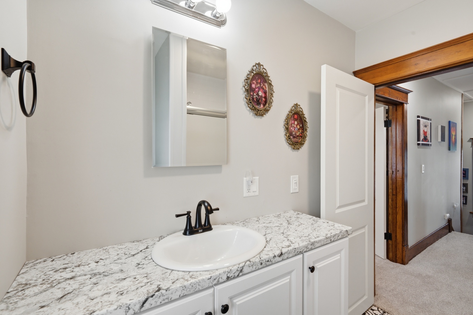 1507 Pershing Boulevard Clinton, IA 52732 - Photo 14 of 29 a bathroom with a granite countertop sink and a mirror