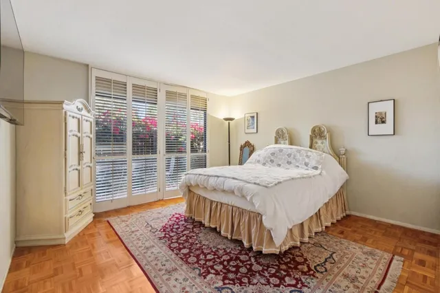 a bedroom with a bed and wooden floor