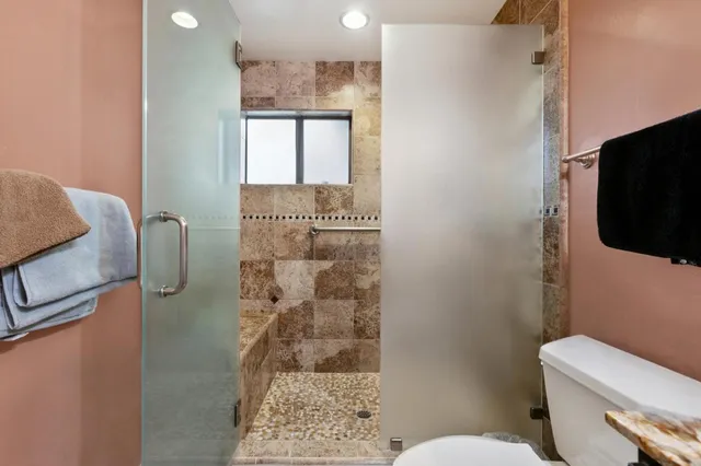 a bathroom with a toilet sink and shower