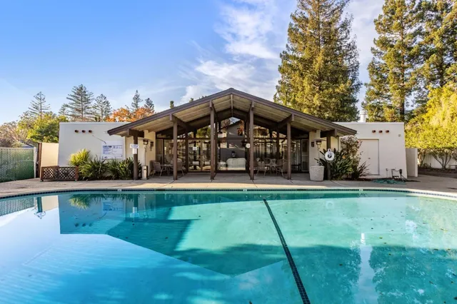 a front view of a house with swimming pool having outdoor seating