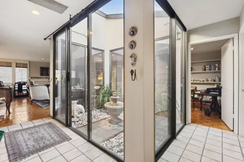 a view of a hallway with living room and furniture