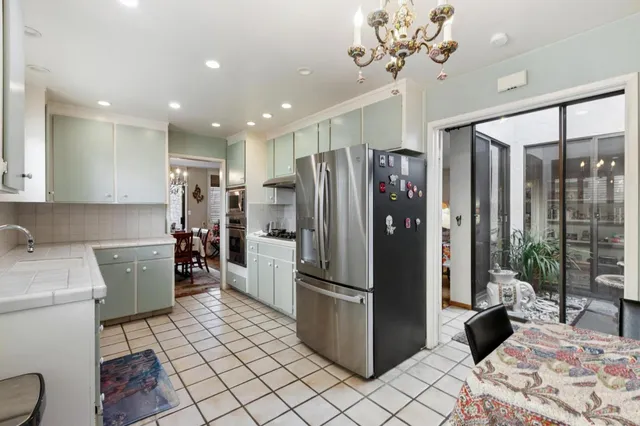a kitchen with a refrigerator and a sink