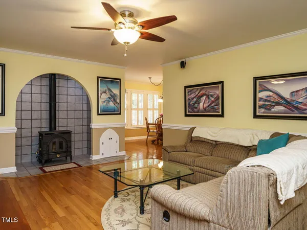 a living room with furniture a fireplace and wooden floor
