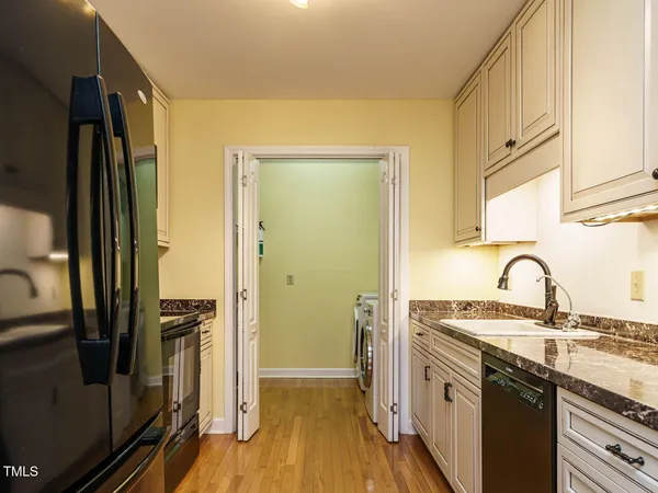 a kitchen with stainless steel appliances a sink stove and refrigerator