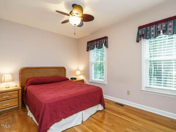 a bedroom with a large bed and a large window