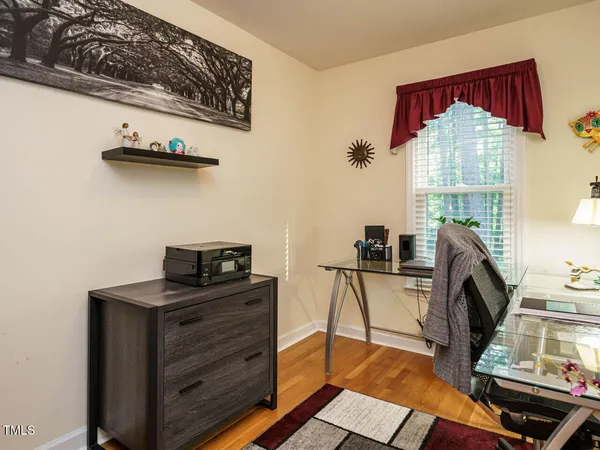 a view of a workspace with furniture and a window