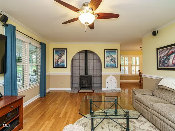 a living room with fireplace furniture and a window