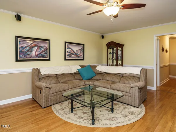 a living room with furniture and a chandelier