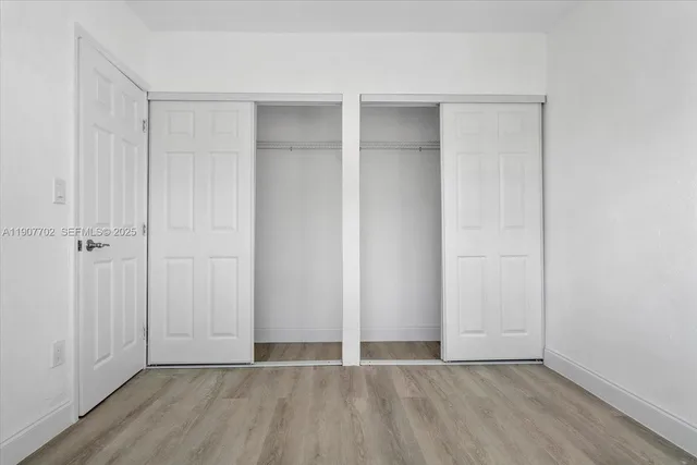 an empty room with wooden floor