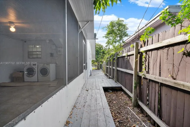 a view of balcony with wooden floor and fence