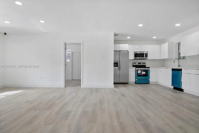 a view of a kitchen with a sink and a stove top oven