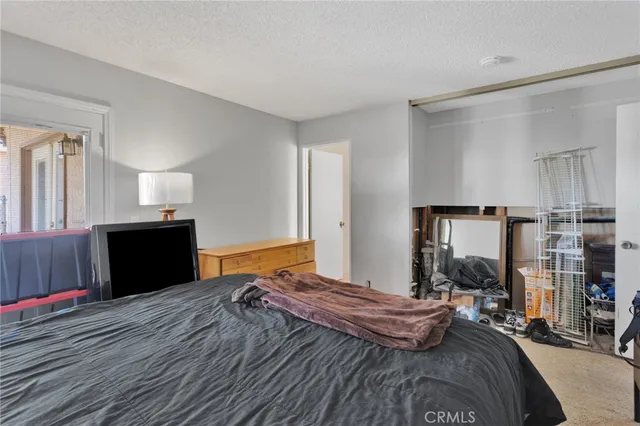 a bedroom with a bed and dresser