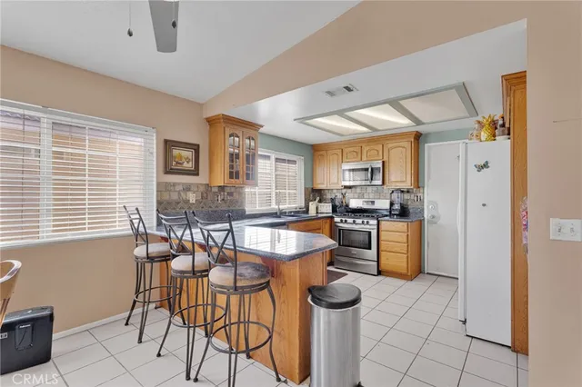 a kitchen with a refrigerator and a stove top oven