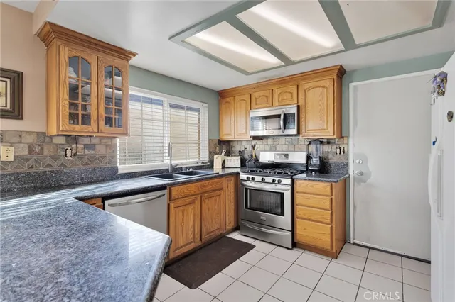 a kitchen with stainless steel appliances granite countertop a stove sink and cabinets