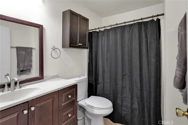 a bathroom with a sink vanity mirror and toilet