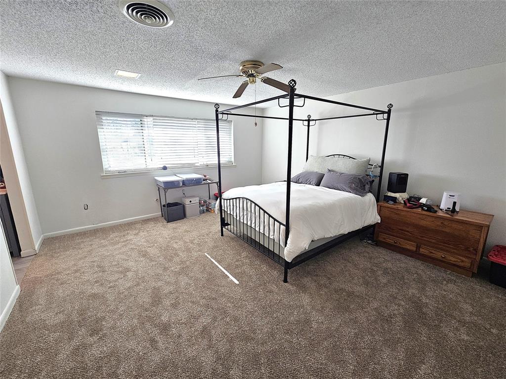 220 North Calhoun Street Groesbeck, TX 76642 - Photo 11 of 24 a bedroom with a bed and window