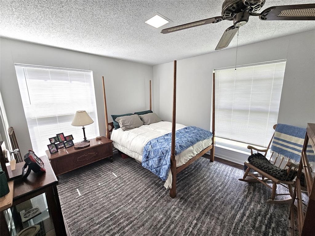 220 North Calhoun Street Groesbeck, TX 76642 - Photo 14 of 24 a bed room with a bed and a chair