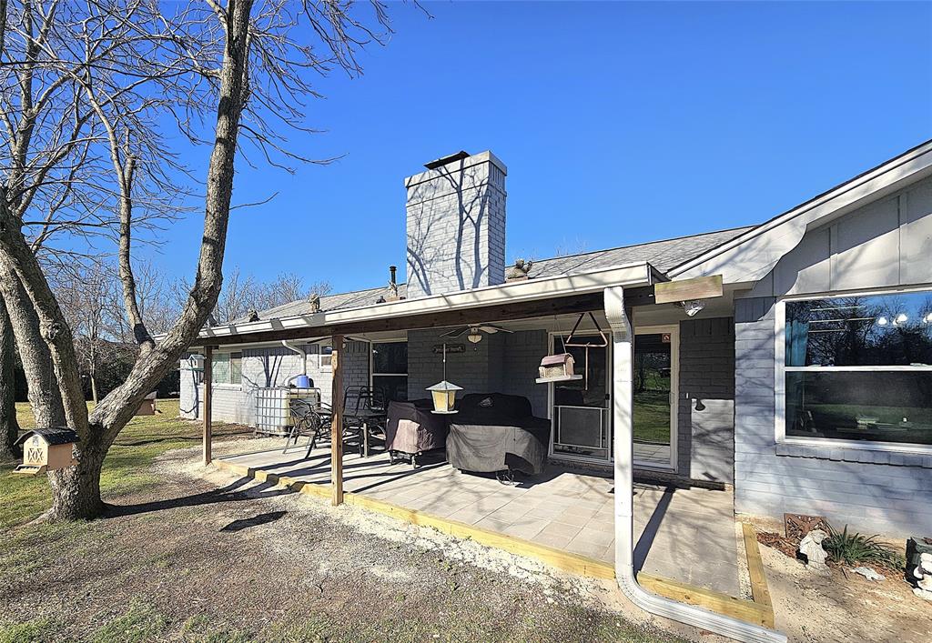 220 North Calhoun Street Groesbeck, TX 76642 - Photo 20 of 24 a view of a patio with a table and chairs and potted plants