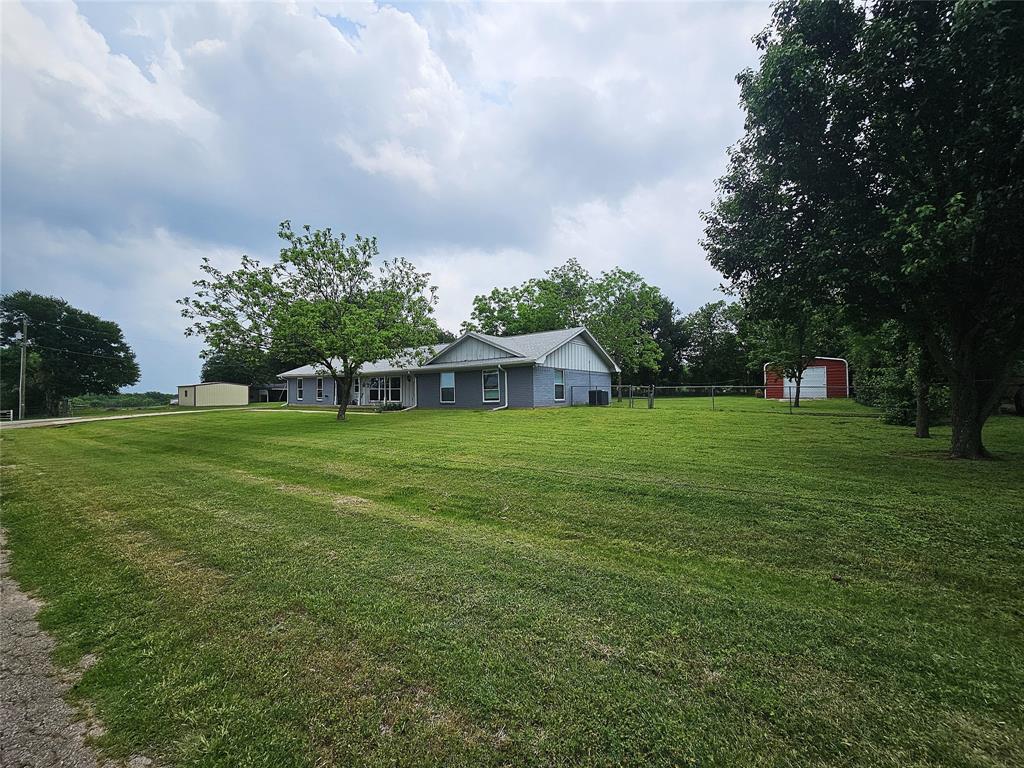 220 North Calhoun Street Groesbeck, TX 76642 - Photo 2 of 24 a view of a house with a big yard