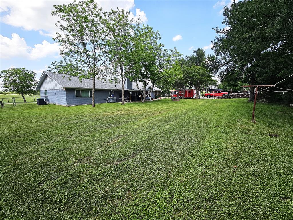220 North Calhoun Street Groesbeck, TX 76642 - Photo 23 of 24 a view of a house with a backyard