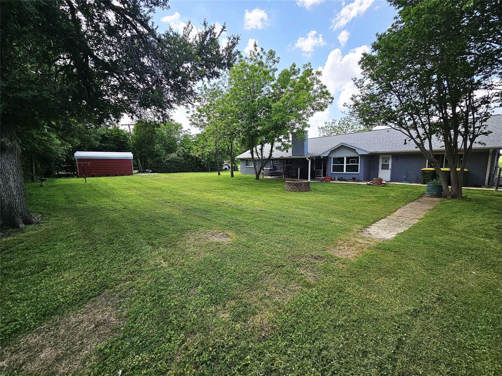220 North Calhoun Street Groesbeck, TX 76642 - Photo 24 of 24 a front view of a house with garden