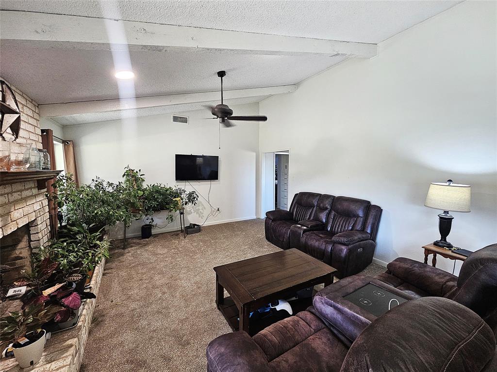 220 North Calhoun Street Groesbeck, TX 76642 - Photo 9 of 24 a living room with furniture and a flat screen tv
