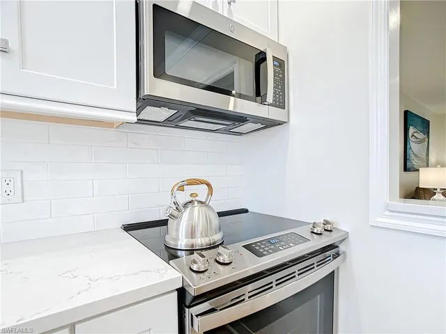 a kitchen with a stove and a microwave