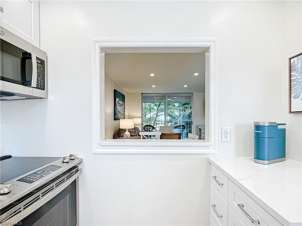 180 Turtle Lake Court, Unit 206 Naples, FL 34105 - Photo 12 of 50 a kitchen with a stove and a microwave