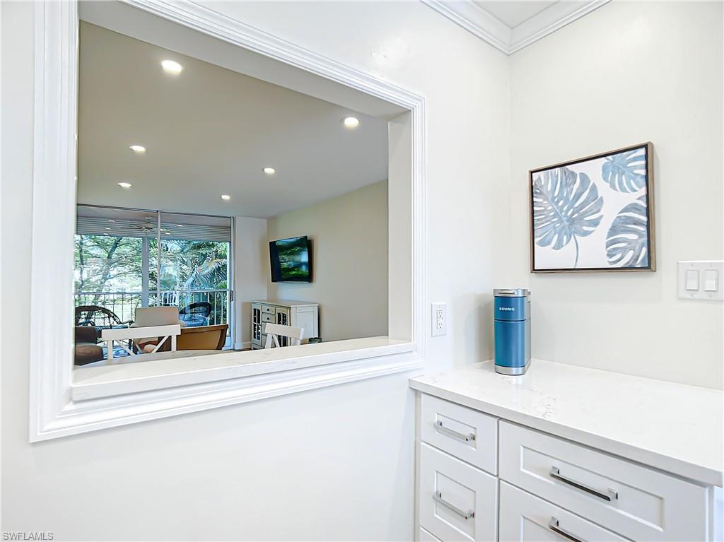 180 Turtle Lake Court, Unit 206 Naples, FL 34105 - Photo 13 of 50 a kitchen with sink and large window