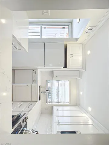 a view of a living room with a fireplace and windows