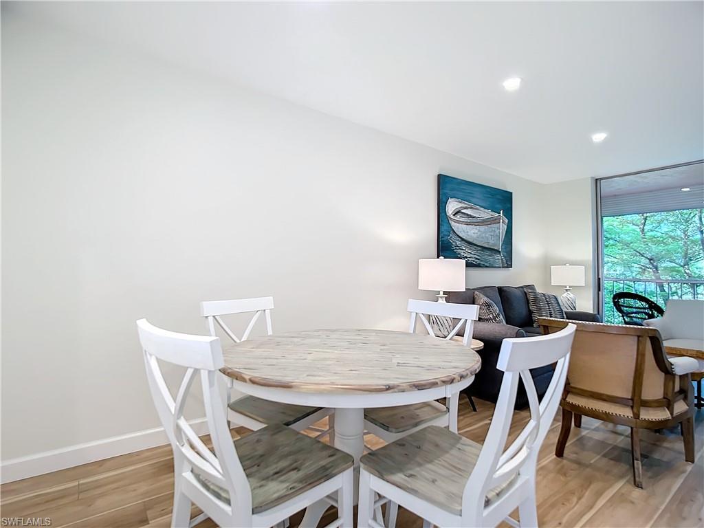 180 Turtle Lake Court, Unit 206 Naples, FL 34105 - Photo 18 of 50 a view of a dining room with furniture and wooden floor